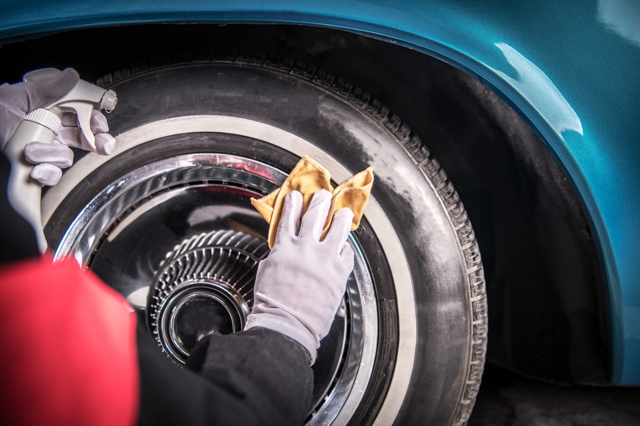 Person detailing wheels and tires