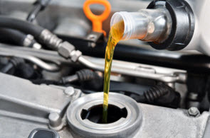 New oil being poured into oil fill opening