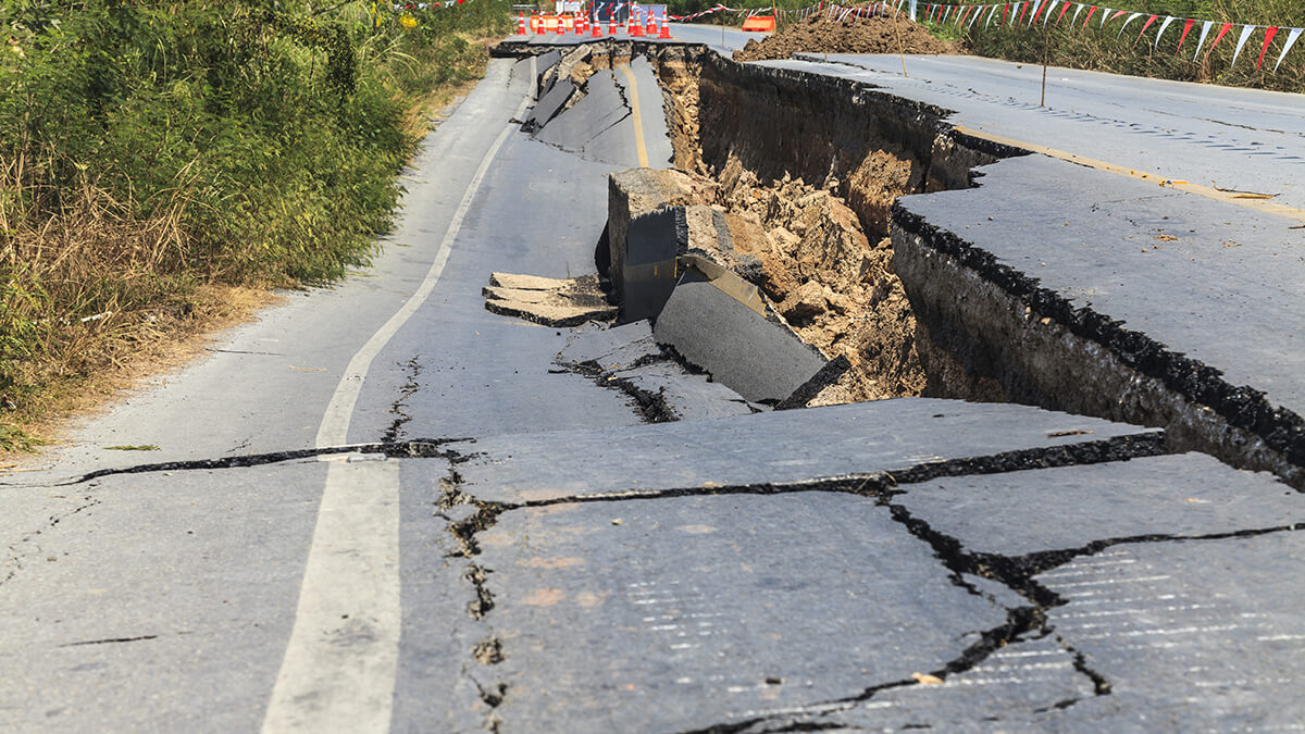 A road that has buckled from earthquake damage