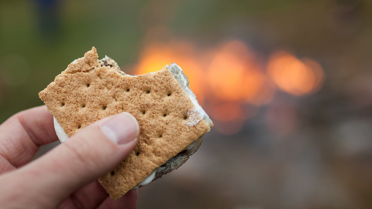 A close-up of a s'more with a bite taken out of it