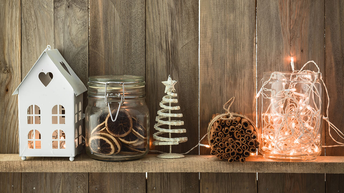 Holiday decorations sitting on a wooden shelf