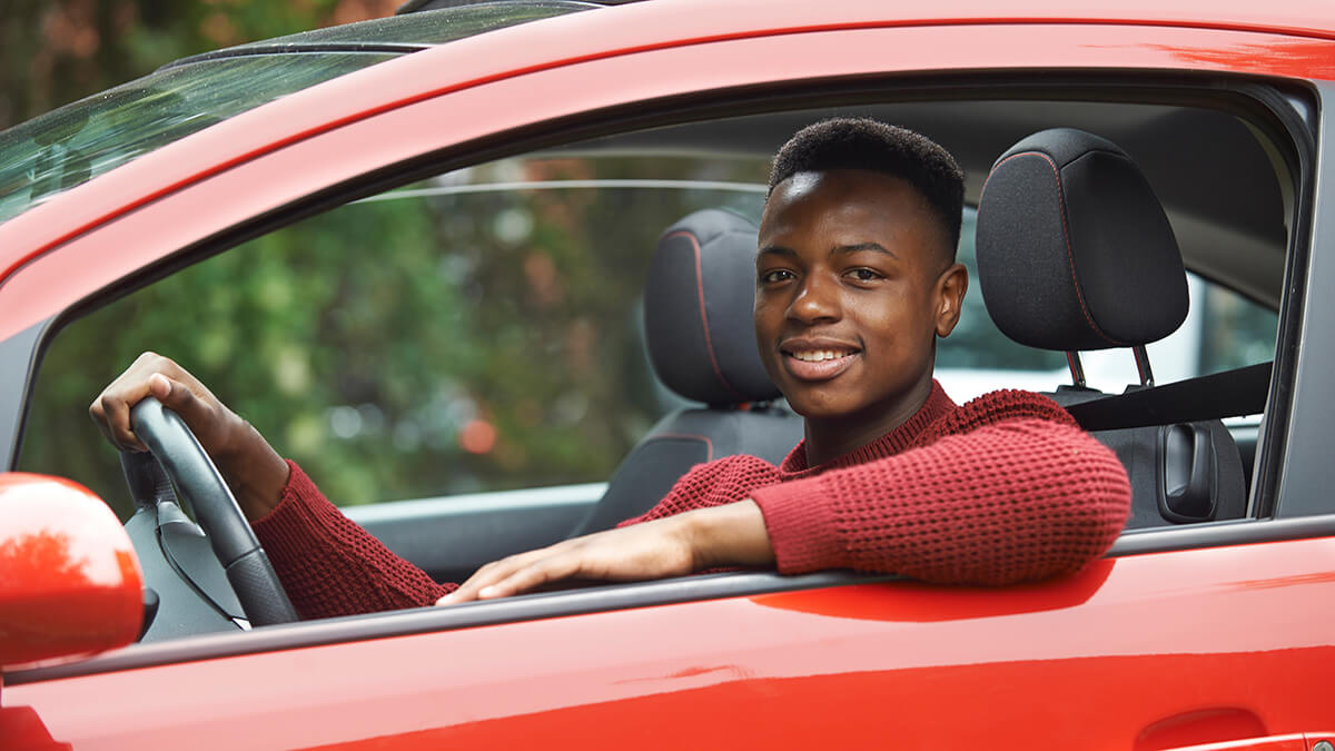 Smiling young man in the driver's seat