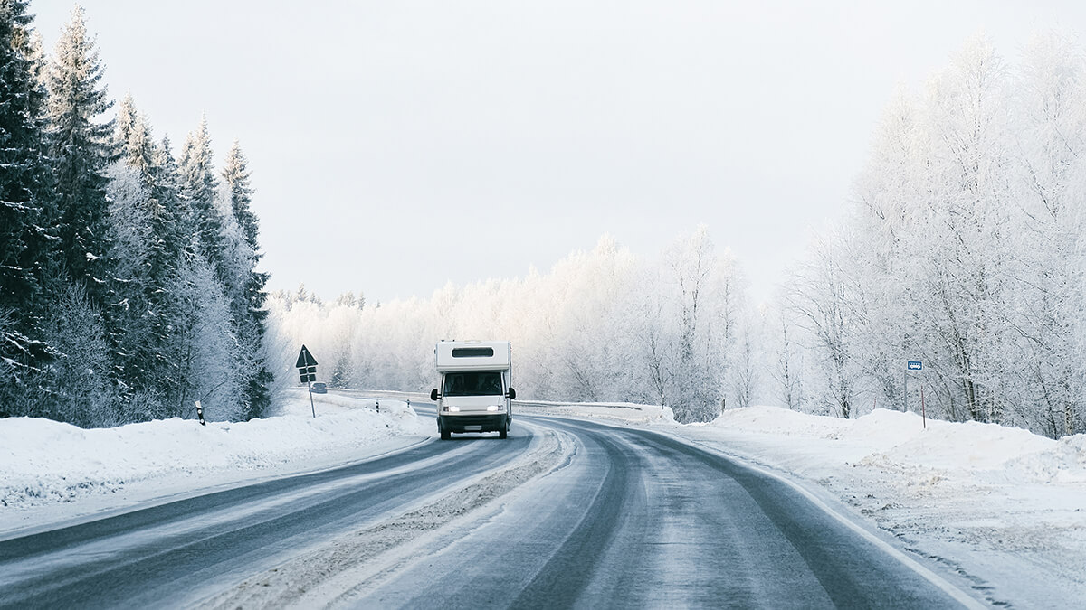 A RV driving on a snowy road