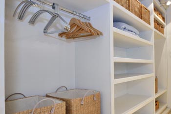 A clean closet utilizing storage systems.