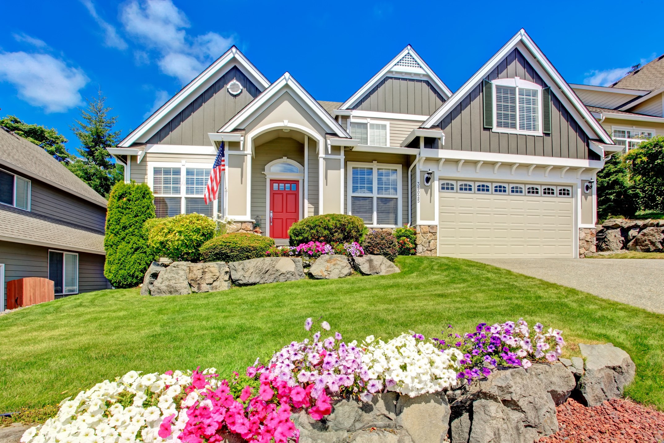 Front view of beautiful home with landscaping rocks and flowers