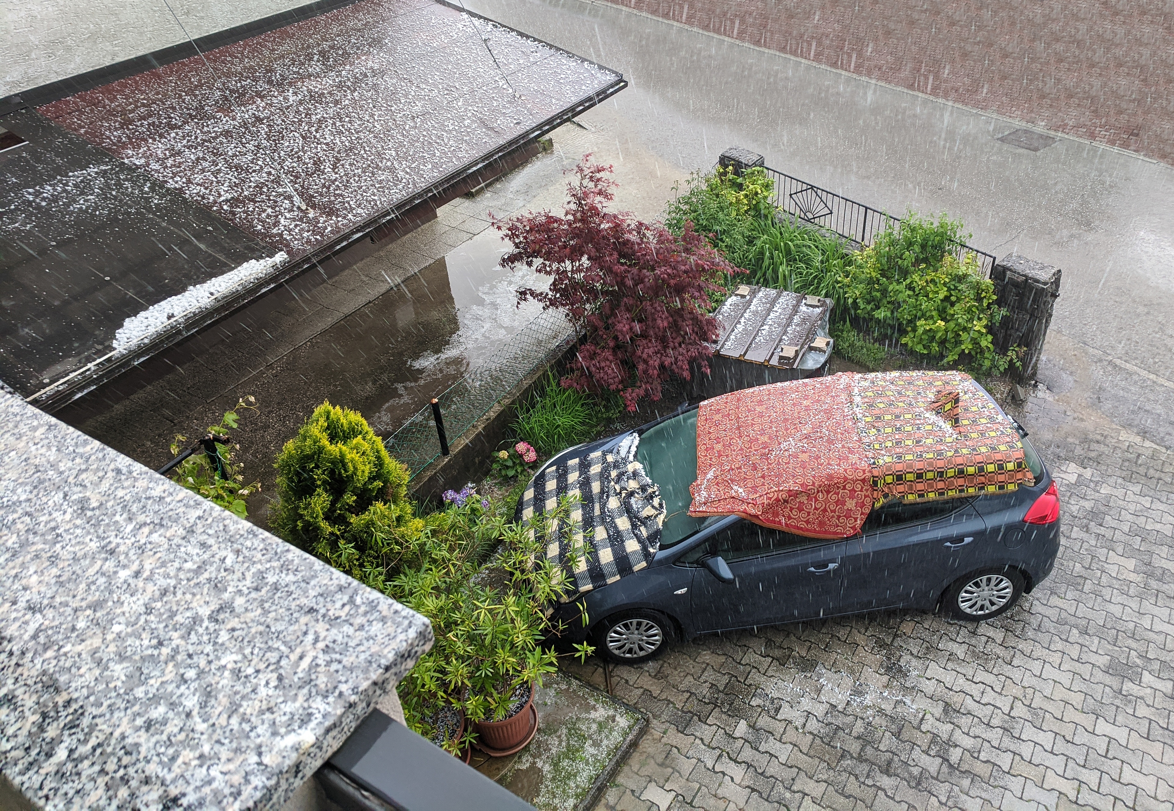 You can use blankets to try to protect your car from hail if you can't park in a garage, and don't have a hail car cover.