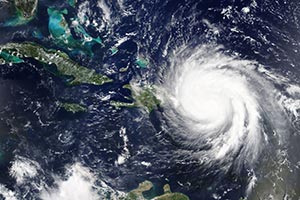 Arial image of large hurricane over ocean approaching islands (opens in new window)