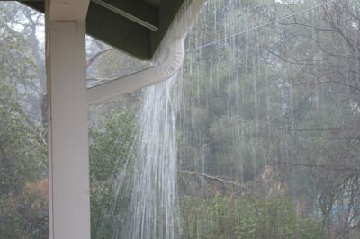 A gutter spilling over rain water