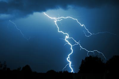 Lightning violently branching across the dark ominous sky