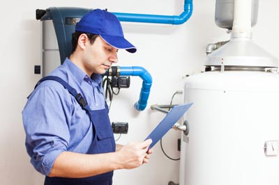 A maintenance person inspecting a water heater